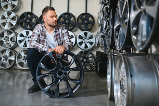 A man choosing between Forged and Cast wheels for his Polaris slingshot